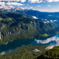 mountains and clouds reflected in lake bohinj slovenia