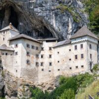 predjama castle built into gray cliff in slovenia