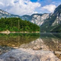 mountains reflected in alpine lake bohinj slovenia