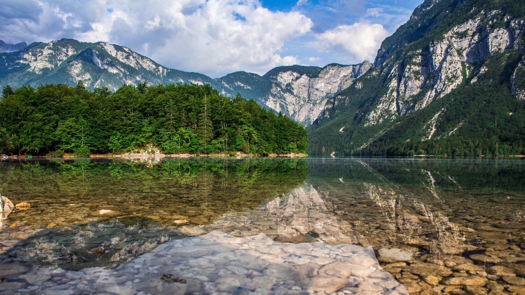mountains reflected in alpine lake bohinj slovenia